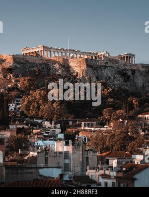 A beautiful sunset over The Parthenon and The Acropolis of Athens atop ...