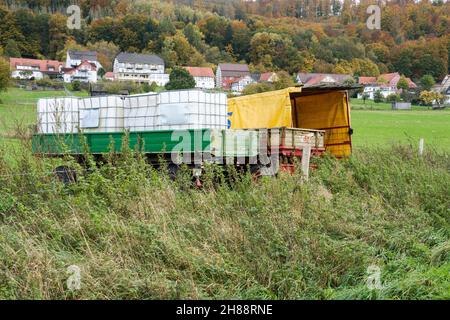Old scrap agricultural machines near Gewissenruh, Wesertal, Weser Uplands, Weserbergland, Hesse, Germany Stock Photo