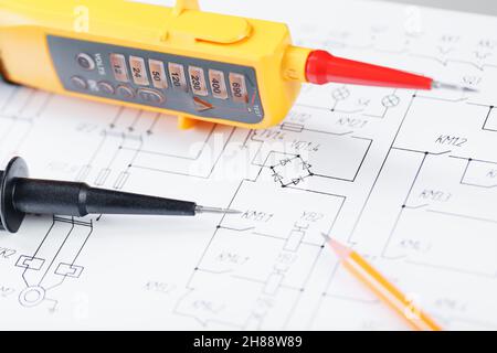 Yellow voltage indicator in close-up on the electrical diagram. Testing and verification of power grids Stock Photo