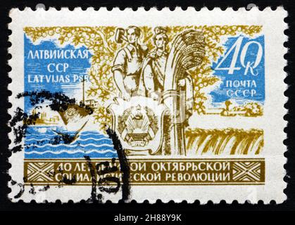 RUSSIA - CIRCA 1957: a stamp printed in the Russia shows Couple, Sea and Field, 40th Anniversary of the October Revolution, circa 1957 Stock Photo