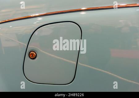 petrol cap cover with lock on a mirroring body of classic car Stock Photo