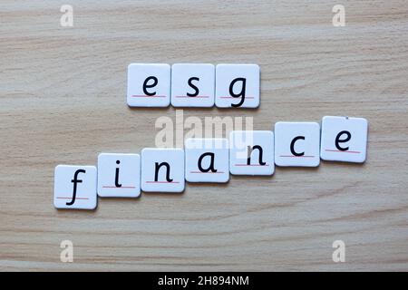 ESG Environmental Social Governance Finance spelled alphabet on wooden plywood background Stock Photo