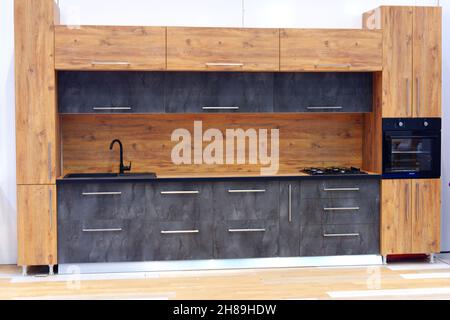 Modern Kitchen Design with decorative wooden details and spotlights indoor. Stock Photo