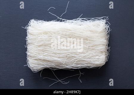 Slate tray with on it's middle a stack of rice noodles. Stock Photo