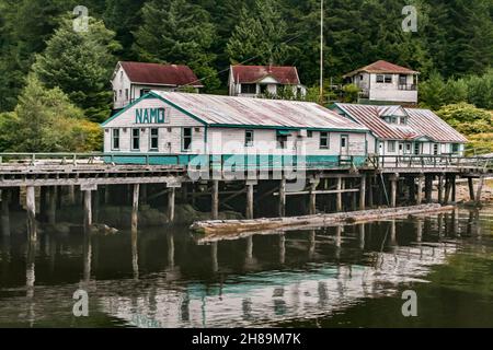 Abandoned houses and buildings stand on the shore and boardwalk at Namu, a historic former cannery and fish plant town on BC's Inside Passage (2009). Stock Photo