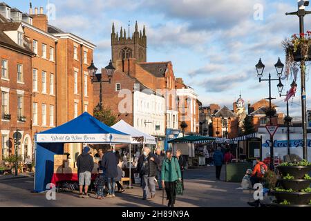 Shoppers at Ludlow Saturday market in the Castle Square on a late autumn day. Shropshire, England Stock Photo