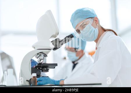 scientists testing the liquid and writing the results in a laboratory journal. Stock Photo