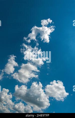 White clouds on a clear blue sky background Stock Photo