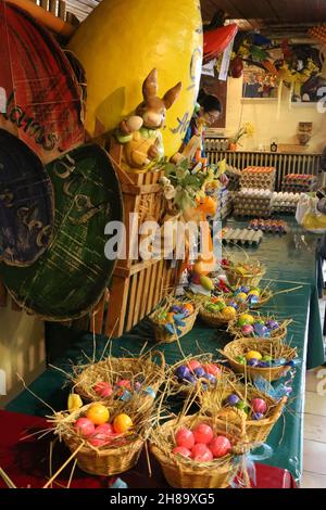 A vertical shot of many wheat baskets with colorful easter eggs in a store Stock Photo