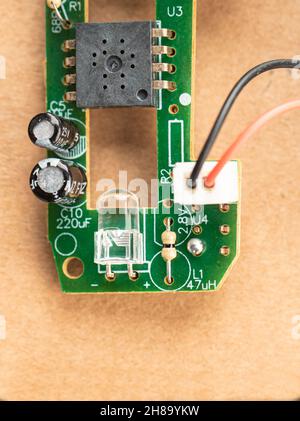Small green board with resistors, capacitors, LED and chip. Close up. Stock Photo