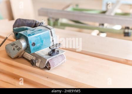 Hand sander on a wooden board. Carpentry Stock Photo