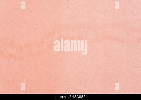 Old plastered wall with, spots. Coral color grunge texture. Abstract background Stock Photo