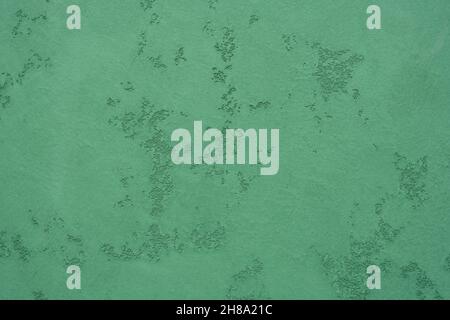 Structural plaster in green. Textured green wall. Wall decoration option. Creative vintage background. Stock Photo