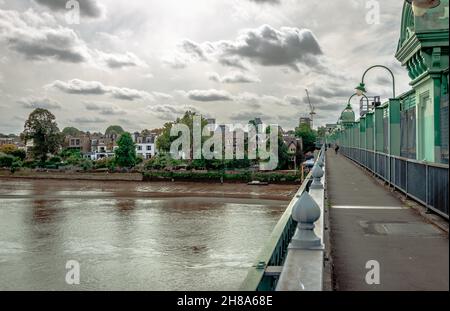 The Fulham Railway Bridge (colloquially The Iron Bridge) that spans river Thames, with Putney in the background. It can also be crossed on foot. Stock Photo