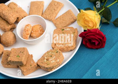 Indian Sweet Til Gul Gur Ke Khasta Gajak Ladoo Burfi Gazak Barfi Gajjak Roll Laddu Tilkut Are Made Of Tilgul, Kaju, Badam, Gud, Pista, Gur And Peanuts Stock Photo