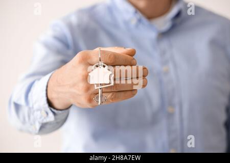 Man holding key from house, closeup Stock Photo