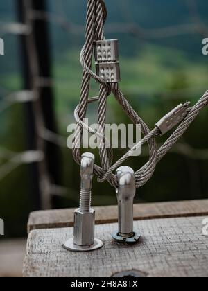 Stainless steel turn buckle and steel wire cable rope connection in detail view Stock Photo