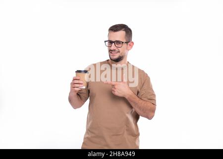 Man Holding Coffee Take Away Cup Pointing at It. Man With To Go Coffee Cup in Hands. Stock Photo