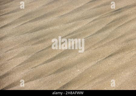 Geometric patterns in the sand left by passing waves Stock Photo