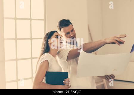 close up. young woman and a designer discussing the design of her new apartment. Stock Photo