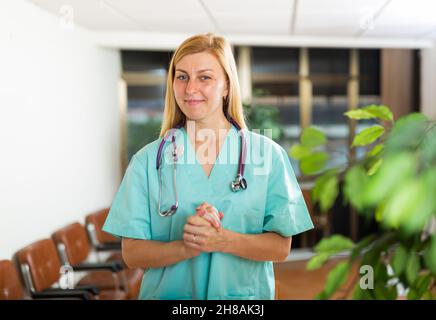 Woman doctor wear white medical uniform and stethoscope look at camera posing in clinic Stock Photo