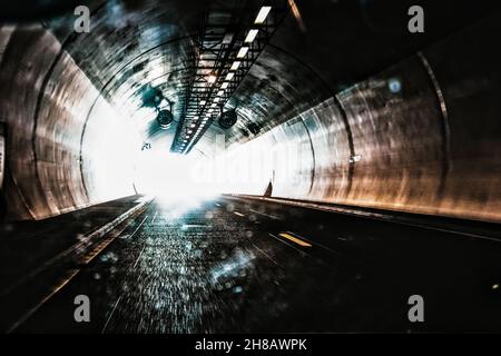 Speeding through a underground tunnel on the motorway towards the light Stock Photo