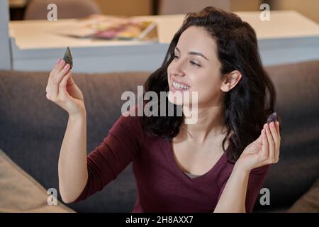 Cheerful lady holding two different quartz crystals Stock Photo