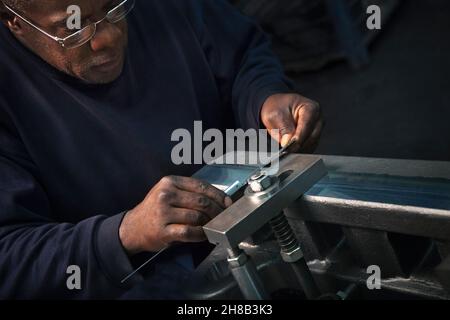 Checking rack bar with a vernier in preparation for further machining Stock Photo