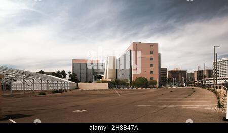 Generic office buildings and empty parking lot in American city. Stock Photo
