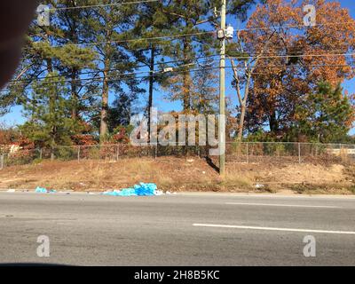 A ragged tarp discarded at roadside Stock Photo