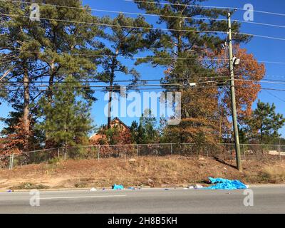 A ragged tarp discarded at roadside Stock Photo