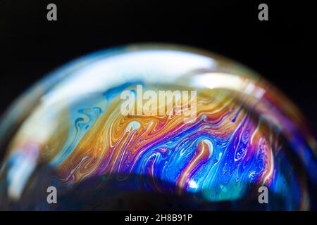 Abstract pattern, multicolored chaotic texture inside of the soap bubble, closeup Stock Photo