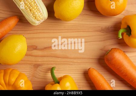 vegetable concept The various types of orange and yellow vegetables being arranged on the wooden table. Stock Photo