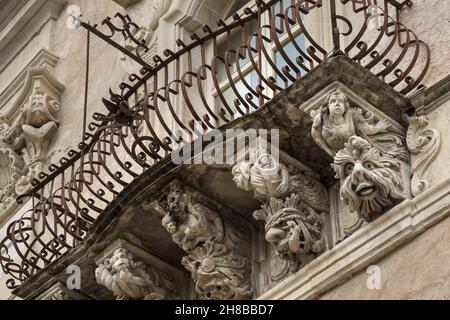 Beautiful baroque mascaron ornament of a balcony in the old town of Ragusa, Sicily Stock Photo