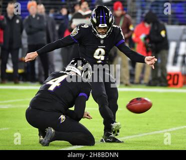 Baltimore, United States. 29th Nov, 2021. Baltimore Ravens kicker Justin Tucker (9) kicks a 52 yard field goal against the Cleveland Browns with an assist from holder Sam Koch (4) during the first half at M&T Bank Stadium in Baltimore, Maryland, on Sunday, November 28, 2021. Photo by David Tulis/UPI Credit: UPI/Alamy Live News Stock Photo