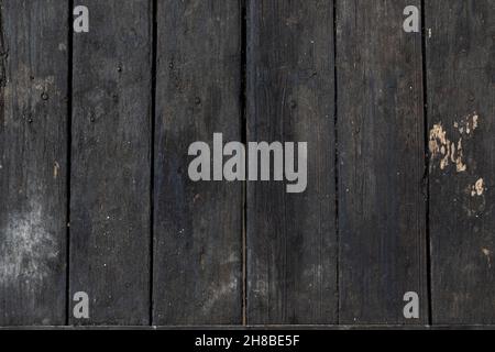 Wooden dark background, wood texture. Black table of boards. Top view. Flat lay. Stock Photo
