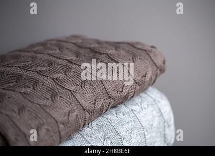 Close-up of textured knitted blankets in a stack. Stock Photo