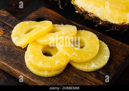 Sliced pineapple set, on old dark wooden table background Stock Photo