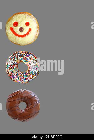 Row of Delectable Assorted Donuts Isolated on Gray Background Stock Photo
