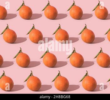 Fruit pattern of fresh tangerine on pink background Stock Photo