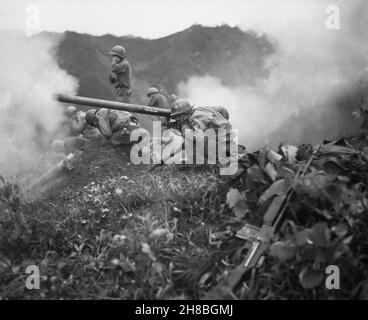 OETLOOK-TONG, KOREA - 09 June 1951 - US Army Private First Class Roman Prauty, a gunner with 31st Regimental Combat Team (crouching foreground), with Stock Photo