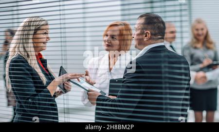 close up . smiling employees discussing financial performance. Stock Photo