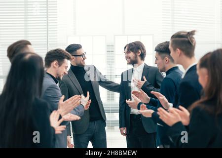 close up. business team congratulating the best employee. Stock Photo
