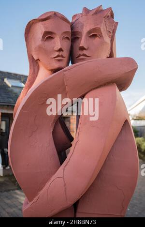 “The Lovers,” Kenneth Allen’s sculpture, of an embracing couple, in the small sculpture courtyard at Gretna Green (Scotland} nr the Blacksmith's shop Stock Photo