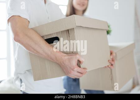 close up. large cardboard box in the hands of a young man. Stock Photo