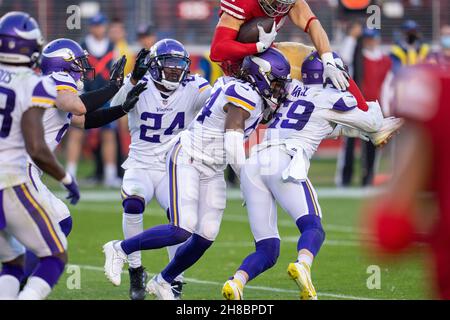 San Francisco 49ers fullback Kyle Juszczyk (44) is upended by Minnesota Vikings offensive tackle Rashod Hill (69) and safety Josh Metellus (44) during Stock Photo