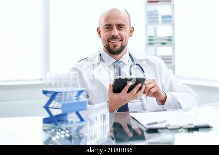 scientist using a digital tablet in a medical lab. Stock Photo