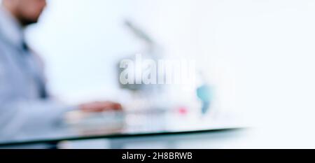scientist using a laptop while working in the lab. Stock Photo