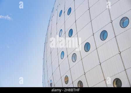 Facade detail of contemporary spherical building with circular windows or portholes shows a quirk architectural building shape. Business concept Stock Photo