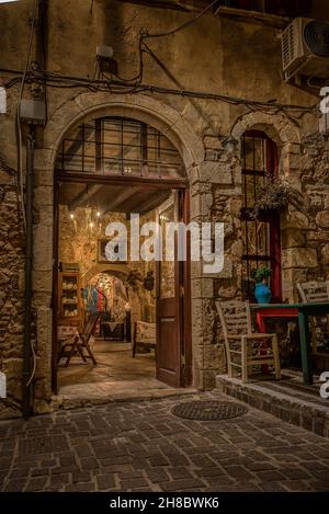 Illuminated entrance to a boutique at the romanticue stairs on the Zampeliou alley in the old town of Chania, Creete, Greece, October 13, 2021 Stock Photo